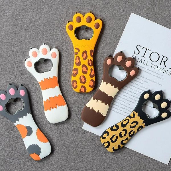 Cute bottle opener with cat's paw motif that can be attached to refrigerator with magnet.
